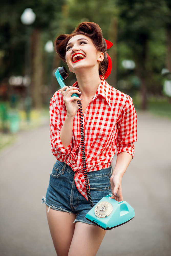 smiling girl making marketing phone call